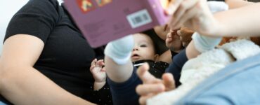 neonato a cui viene letto un libro
